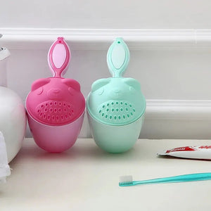 Becmella tear free baby rinse cup set in pink and mint with bear face design and hanging loop on bathroom counter
